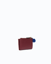Portefeuille multifonction en cuir avec pompon - | Pinko